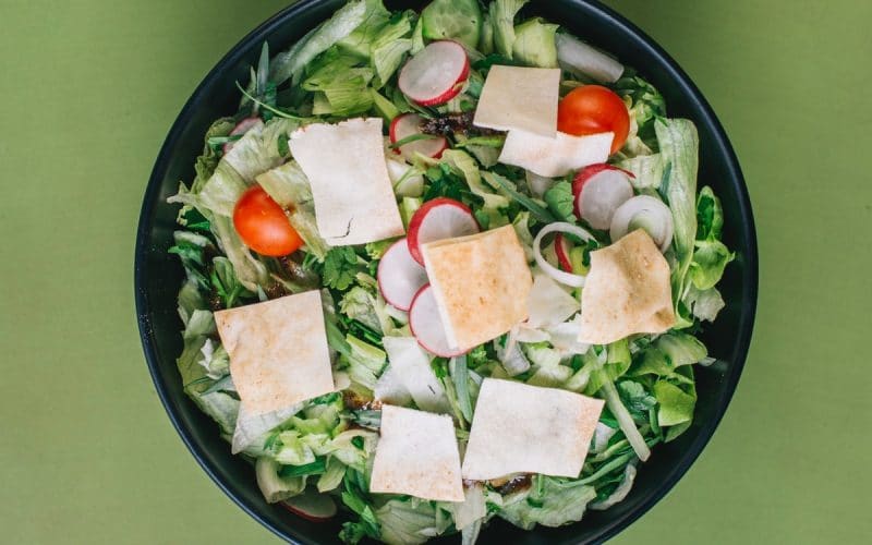 green salad on a black bowl