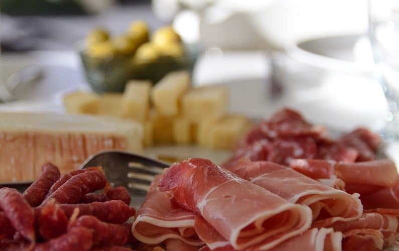 raw meat on white ceramic plate